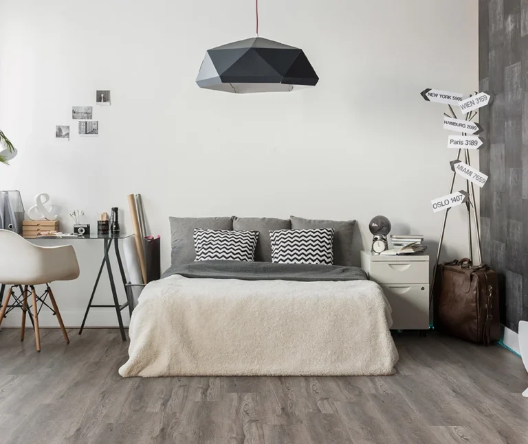 A cozy modern bedroom featuring resilient vinyl flooring & timber wood planks decking