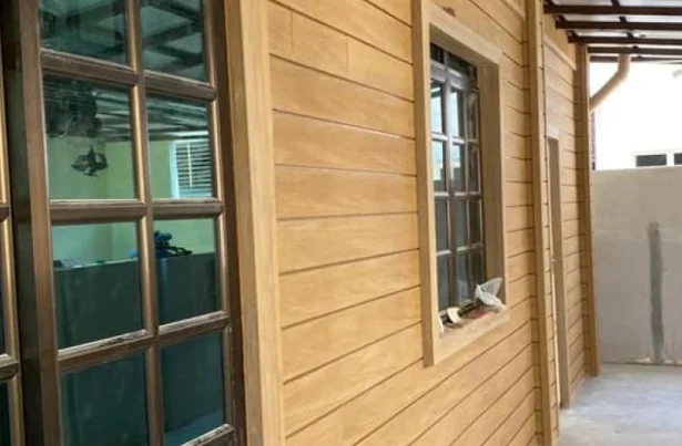 Showcase of composite wood wall cladding used as the outdoor wallpaper of a small house
